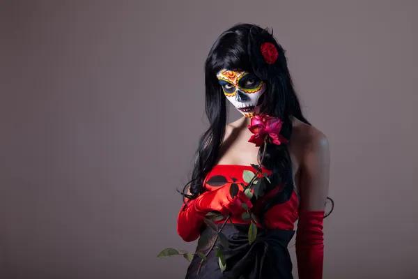 depositphotos_12901428-stock-photo-sugar-skull-girl-holding-red.jpg